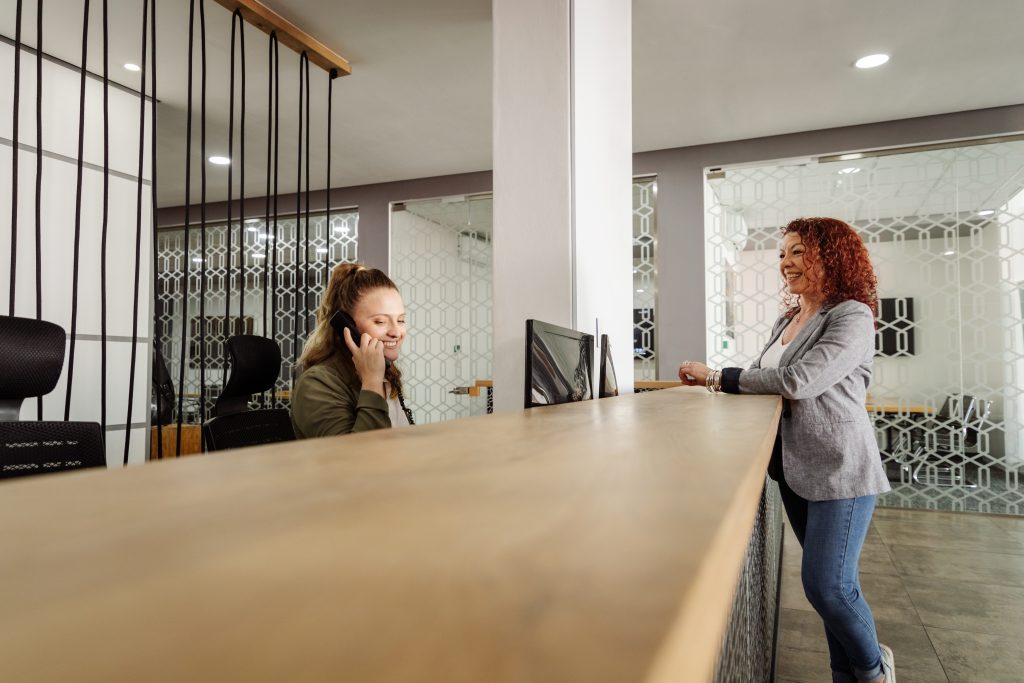 two women at reception desk