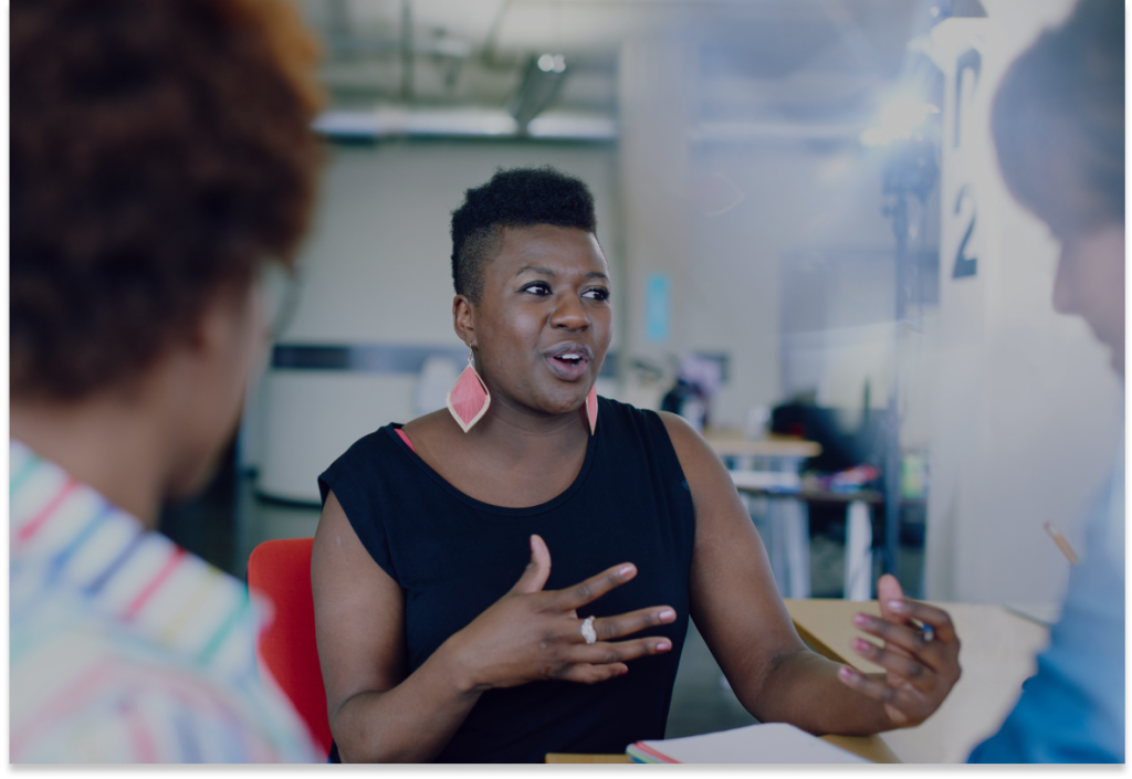 Woman explaining idea to two other people