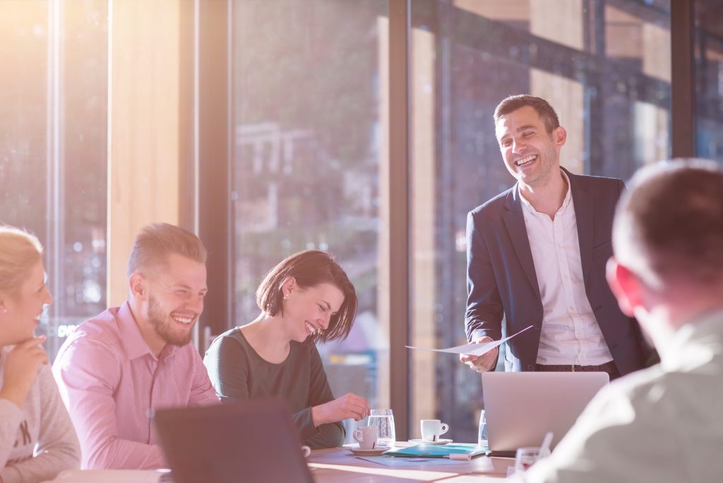 people in a meeting laughing