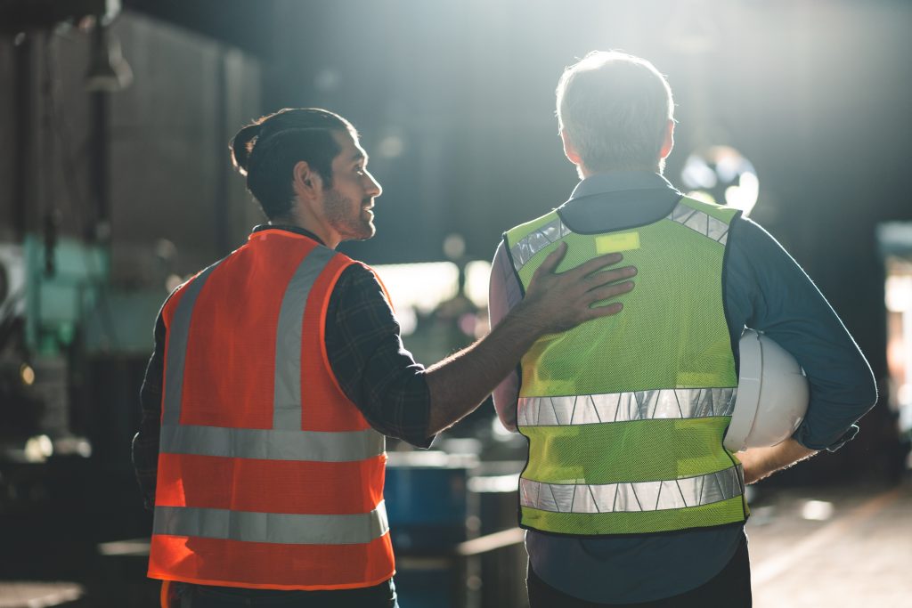 two engineers looking at project in a factory