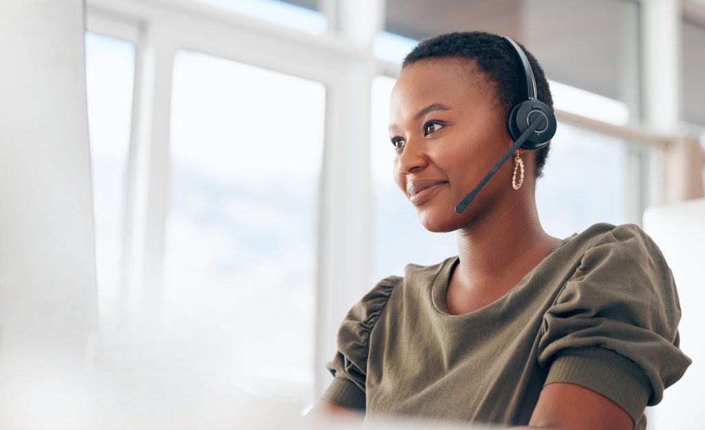 woman working at desk with headpiece