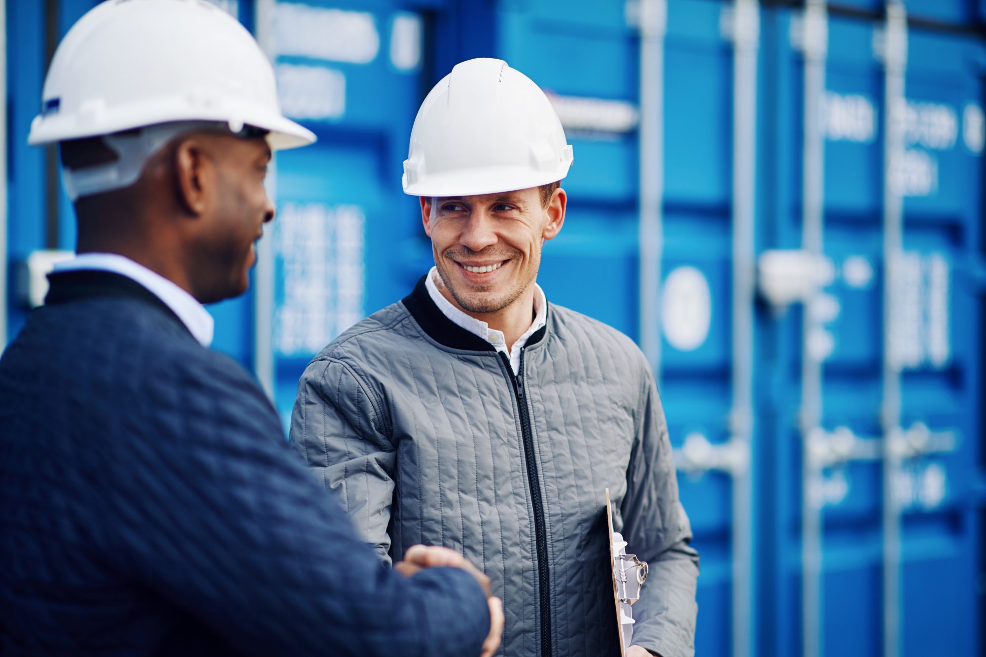 Two engineers in PPE shaking hands