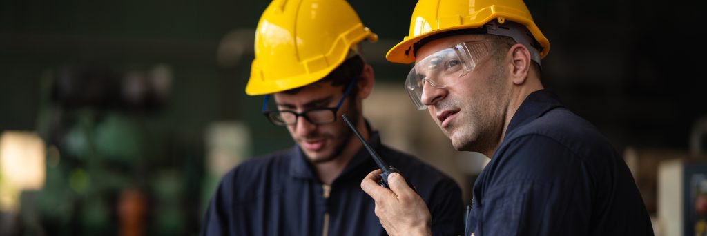Two engineers in PPE working on project