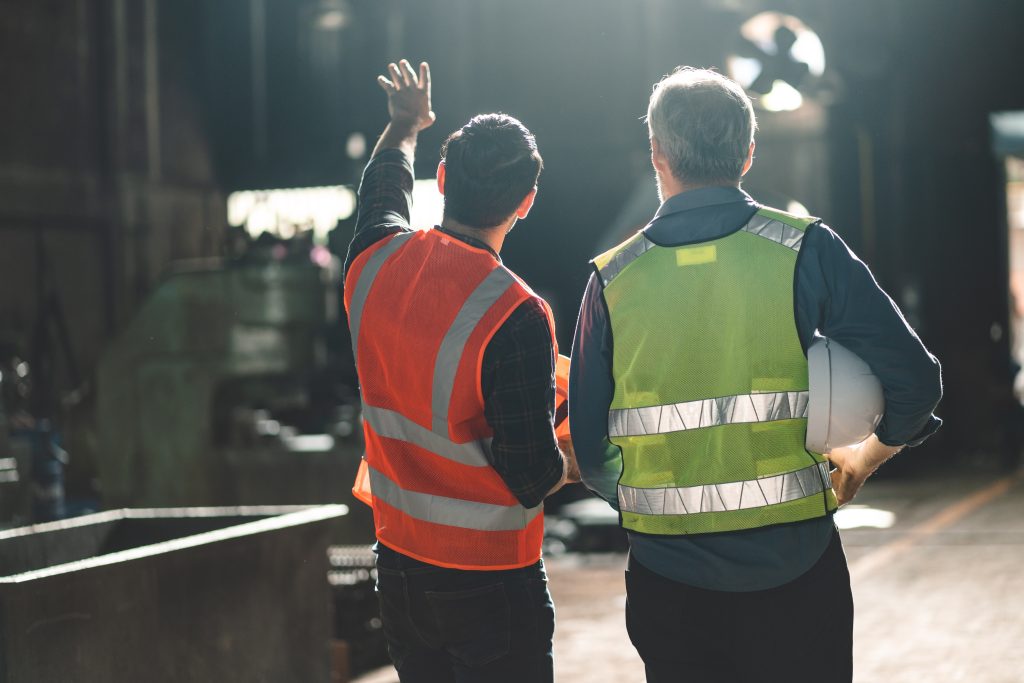 two engineers looking at project in a factory